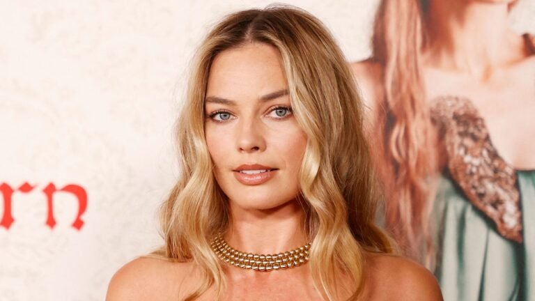 Margot Robbie’s Sheer Corset Dress Has Her Own Navel Piercing – See Photos